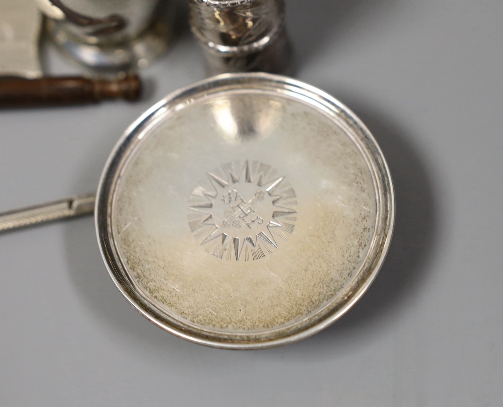 A quantity of small silver or white metal items including a long handled server spoon, Chinese pepperette, pair of Victorian pepperettes, Victorian silver paten, 19th century toddy ladle by Taylor & Perry, folding comb,